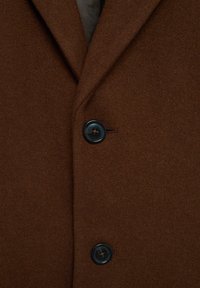 Brown wool coat featuring a textured fabric, two large black buttons, and a tailored design with a straight cut.