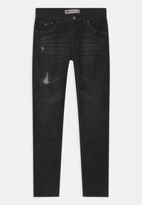 Black skinny jeans made of denim, featuring distressed details, a classic five-pocket design, and subtle fading throughout.