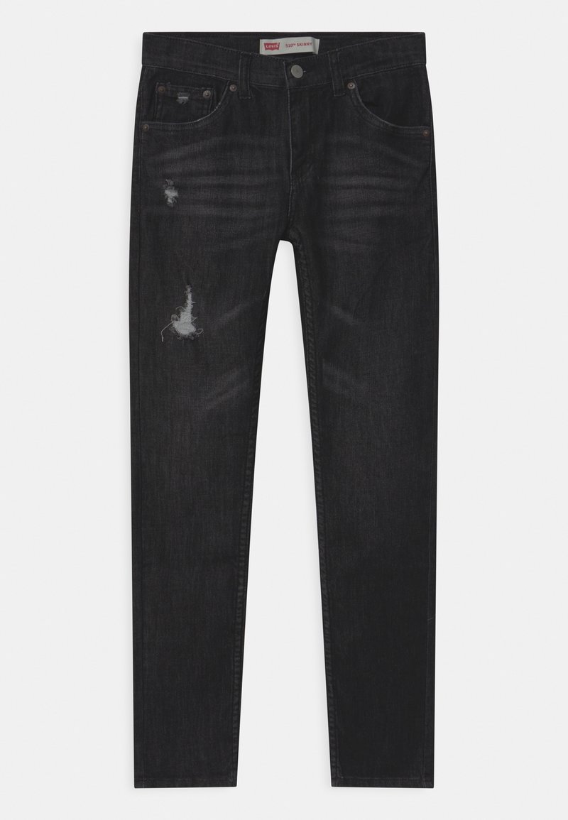 Black skinny jeans made of denim, featuring distressed details, a classic five-pocket design, and subtle fading throughout.