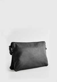 Bolso clutch de piel negra con una textura suave, forma rectangular y cierre de cremallera. Cuenta con una correa lateral para mayor comodidad.