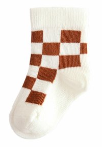 Vit strumpa med rutigt mönster i brunt. Tjock ribbad mudd och mjuk textur. Rundad tådesign med sömlös finish.