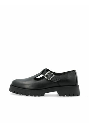 Black leather Mary Jane shoe with a silver buckle strap and a thick, treaded sole, shown from the side on a white background.