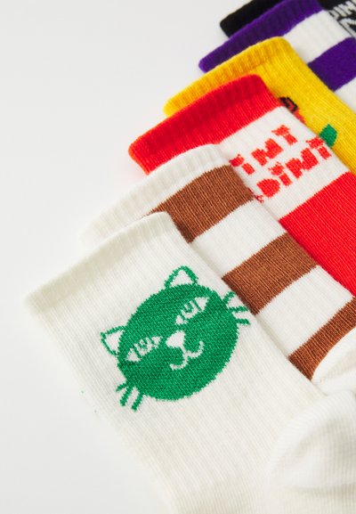 Colorful socks featuring a green cat face pattern on a white background, alongside striped and solid designs in various colors.