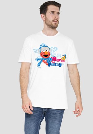 White cotton t-shirt featuring a colorful graphic of a character in winter attire, with blue accents and the text "Warm and Fuzzy" in bold.