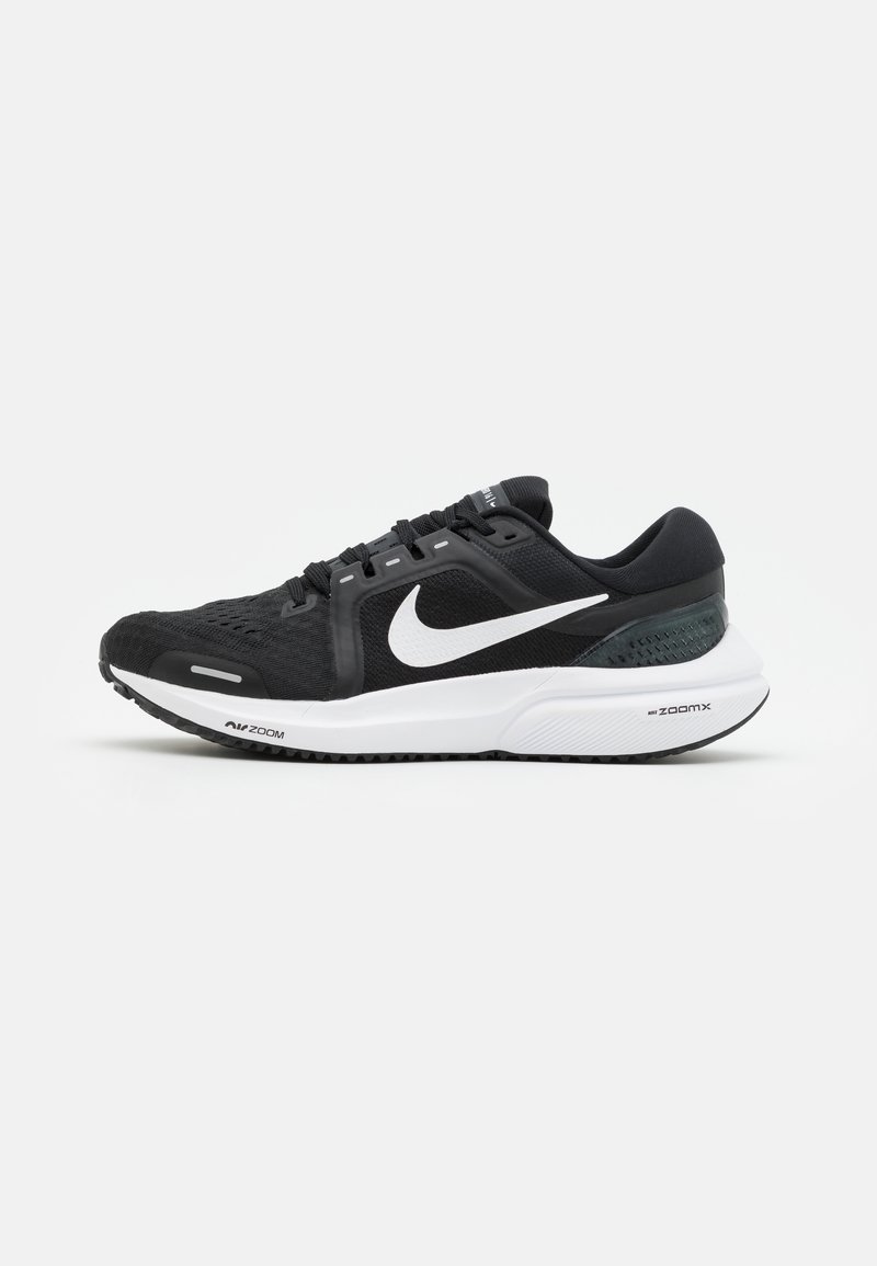 Black athletic shoe featuring a mesh upper, white Nike swoosh, and a cushioned white sole with textured grip. Zoom technology visibly displayed.