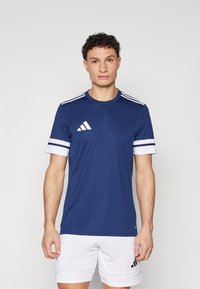 Navy blue athletic t-shirt with white stripes on sleeves and three white stripes on shoulders, made from a smooth, breathable fabric.