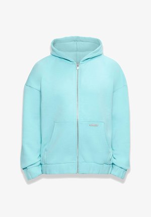 Světle modrá mikina na zip vyrobená z měkké látky, se širokou kapucí, předními kapsami a žebrovanými manžetami. Diskrétní logo na kapse.