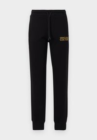 Sorte joggebukser laget av myk stoff, med elastisk midjebånd og snor, samt gult brodert "VERSACE JEANS COUTURE"-logo.