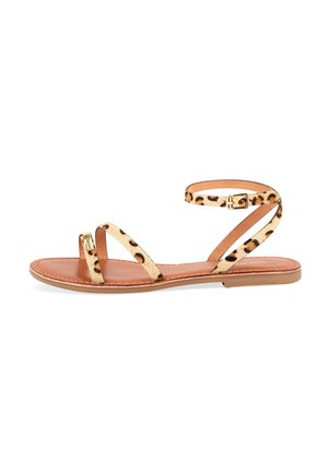 Sandali flat con stampa leopardata, dotati di cinturini sottili e una cinghia alla caviglia con fibbia, con una soletta in pelle color nocciola e una suola flessibile.