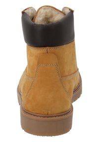 Stivale alla caviglia beige in suede con colletto in pelle nera, interni imbottiti e suola in gomma. Include cuciture visibili e una finitura testurizzata.