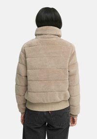 Beige fleece jack met horizontaal geruit patroon, hoge kraag en ribbelafwerking. Zachte textuur, cropped lengte. Achteraanzicht weergegeven.