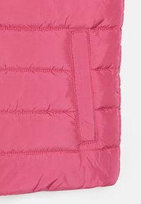 Pink puffer jacket section with quilted design, shiny finish, and side pocket detail. Smooth texture, featuring visible stitching lines.