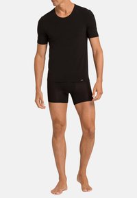 Black short-sleeve t-shirt and matching boxer briefs, both made of lightweight, stretchy fabric with a smooth texture and fitted design.