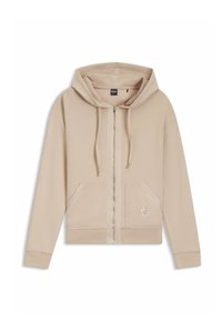 Sudadera beige con cremallera de tejido suave, que presenta una cremallera frontal, dos bolsillos y un logo bordado en el bolsillo izquierdo.