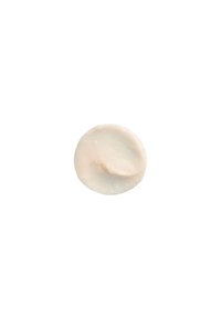 Romig lichtbeige ronde cosmetische product met een gladde textuur en een subtiele glans, met een lichte indentatie in het midden.