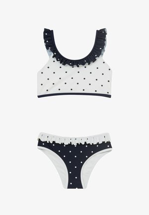 Tweedelig bikini met witte en marineblauwe polkadots, met gerafelde rand bij de bovenkant halslijn en de tailleband van de onderkant.