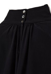 Black fabric blouse featuring a high collar, three-button closure at the neck, and pleats down the front, with a soft, smooth texture.