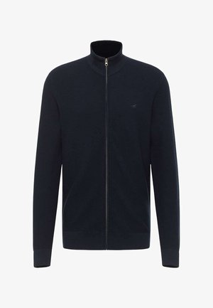 Cardigan bleumarin cu fermoar, realizat dintr-un material texturat. Are un gât înalt, manșoni lungi și un mic logo pe pieptul stâng. Detaliu cu fermoar argintiu.