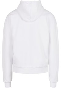 Sweat à capuche blanc de coupe courte. Présente une texture douce et des poignets côtelés, avec une apparence minimaliste et épurée.