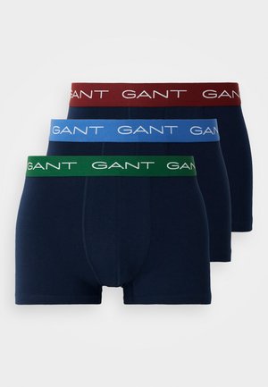 Tričko pánskych boxeriek v námorníckej modrej farbe, s farebnými pásmi. Pásy sú červené, modré a zelené, s bielym logom "GANT".