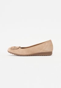 Ballet flat in suede beige con punta arrotondata, dettaglio intrecciato decorativo sul davanti e suola a cuneo bassa e testurizzata.