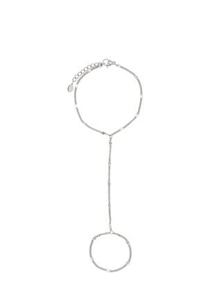 Delicate silver chain hand bracelet with adjustable clasp connecting a wrist bracelet to a finger loop by a slim chain.