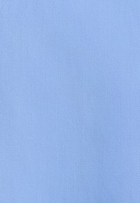 Tessuto azzurro chiaro con una sottile texture rigata diagonale, superficie liscia e colore uniforme.