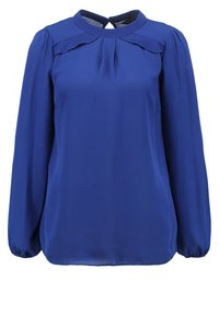 Blusa blu royal con maniche lunghe a palloncino e scollatura tonda. Presenta dettagli a pieghe sulle spalle e una apertura a goccia sulla schiena.