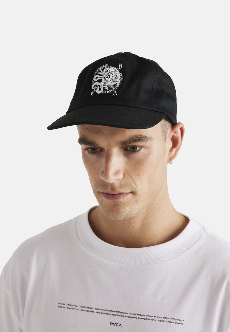 Black cap with a front embroidered octopus design in white. Structured shape, curved brim, and adjustable strap at the back.