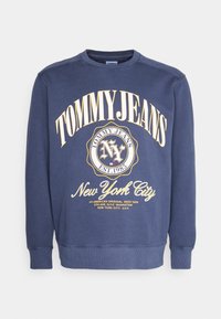 Felpa blu navy in cotone, con una grande stampa grafica gialla. Girocollo e polsini a costine con vestibilità rilassata.