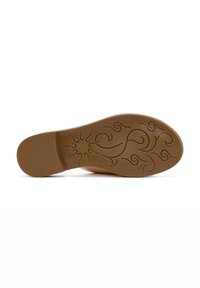 Suela de goma marrón con superficie texturizada; presenta intrincados patrones en espiral y un diseño similar a un sol en el centro. Forma plana, altura mínima.