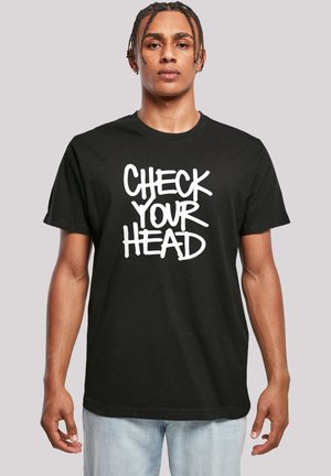 Black cotton t-shirt featuring the text "CHECK YOUR HEAD" in large white, bold lettering. Classic round neck and short sleeves.