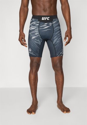 Black athletic shorts with a UFC logo, featuring a dynamic gray and white pattern, a stretchy waistband, and a mid-thigh cut.