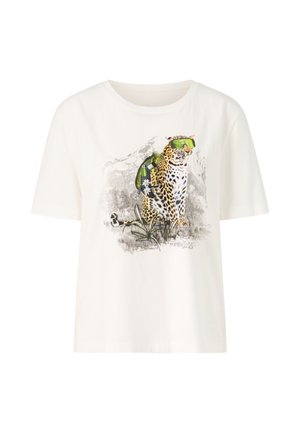 White cotton t-shirt with a short sleeve and loose fit, featuring a graphic of a leopard wearing green accessories and surrounded by foliage.