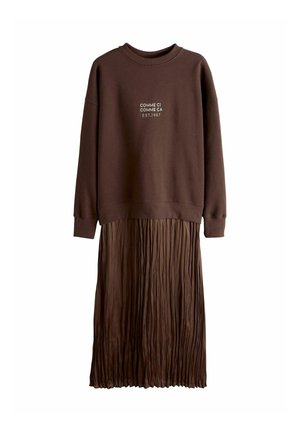 Brown layered dress with a sweatshirt top and pleated skirt. Features "COMME CI COMME ÇA EST.1987" printed in white on the chest.