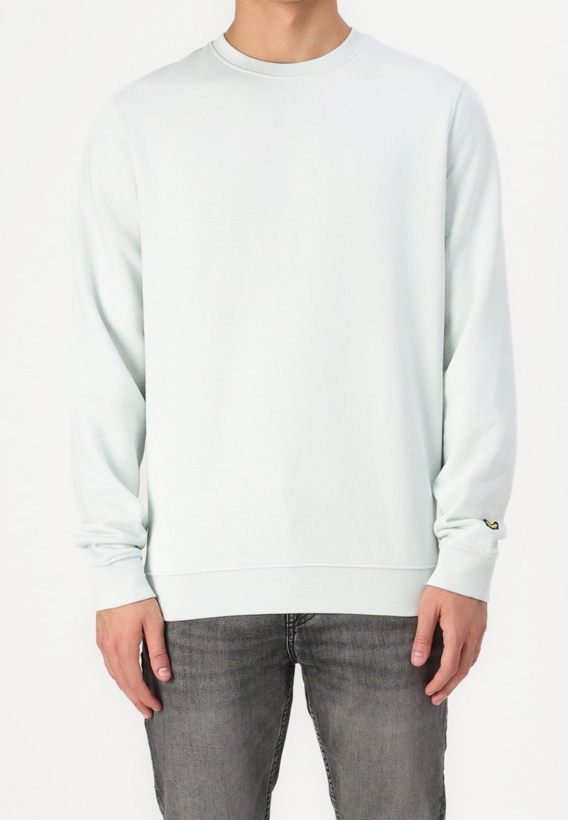 Světle mátově zelená mikina z měkké látky, s dlouhými rukávy, kulatým výstřihem a malým logem na přední straně.