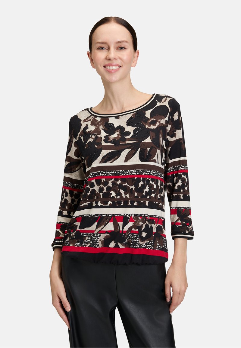 Top a maniche lunghe con un design a più motivi che include fiori, stampe animali e righe in nero, beige, rosso e marrone, realizzato in un tessuto morbido.