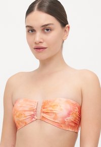 Strapless bikini top featuring a floral pattern in orange and pink hues, with ruched detailing and a small front clasp. Smooth fabric texture.