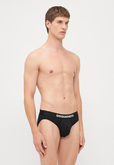 Schwarze Boxershorts mit strukturiertem Muster und elastischem Bündchen mit "DSQUARED2"-Branding in Weiß. Slim-Fit-Design.