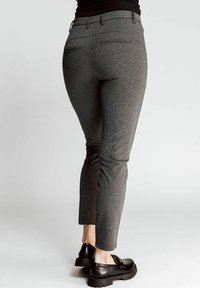 Gray tailored pants with a slim fit, featuring two back pockets, belt loops, and a smooth texture. Paired with black shoes.