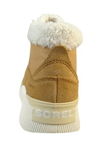 Tan suede shoe with white faux fur collar, rounded heel, and textured rubber sole. Logo "SOREL" featured on the heel.