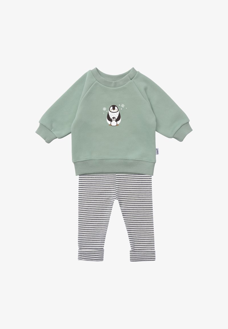 Green sweatshirt with a penguin graphic, paired with black and white striped leggings. Soft cotton material and ribbed cuffs.