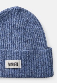 Beanie lavorato a maglia in diverse tonalità di blu, con una texture a coste e un orlo piegato. L'etichetta esposta riporta la scritta "DRYKORN."