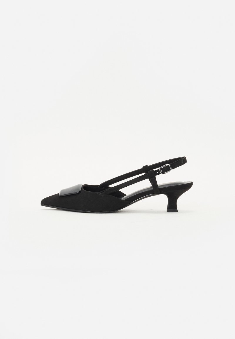 Black suede slingback heels with pointed toe, low stiletto heel, and a large glossy black accent on the vamp. Two slim straps for support.