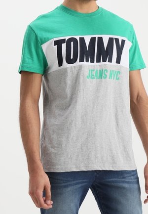 Grøn og grå kortærmet t-shirt med fed "TOMMY" logo i marineblå og "JEANS NYC" tekst nedenfor. Bomulds materiale, rund hals design.