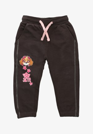 Dunkelbraune Jogginghose mit pinkem Kordelzug, versehen mit einer Cartoon-Hundgrafik und Pfotenabdrücken. Seitliche Nahtdetails sorgen für Struktur.