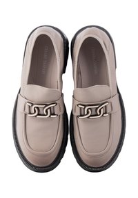 Beige leather loafers with a black rubber sole, featuring a chain link accent across the vamp and subtle stitching details.