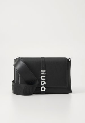 Black leather handbag with a rectangular shape, featuring a silver "HUGO" logo and an adjustable strap with embossed branding.