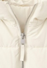 Chaqueta acolchada blanca con cuello alto y cremallera de doble sentido. Textura suave con secciones acolchadas. Acabados de hardware en color plateado.
