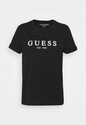 Sort T-shirt med korte ærmer og hvidt print "GUESS EST. 1981" foran, rund hals og små foldede manchetter på ærmerne.